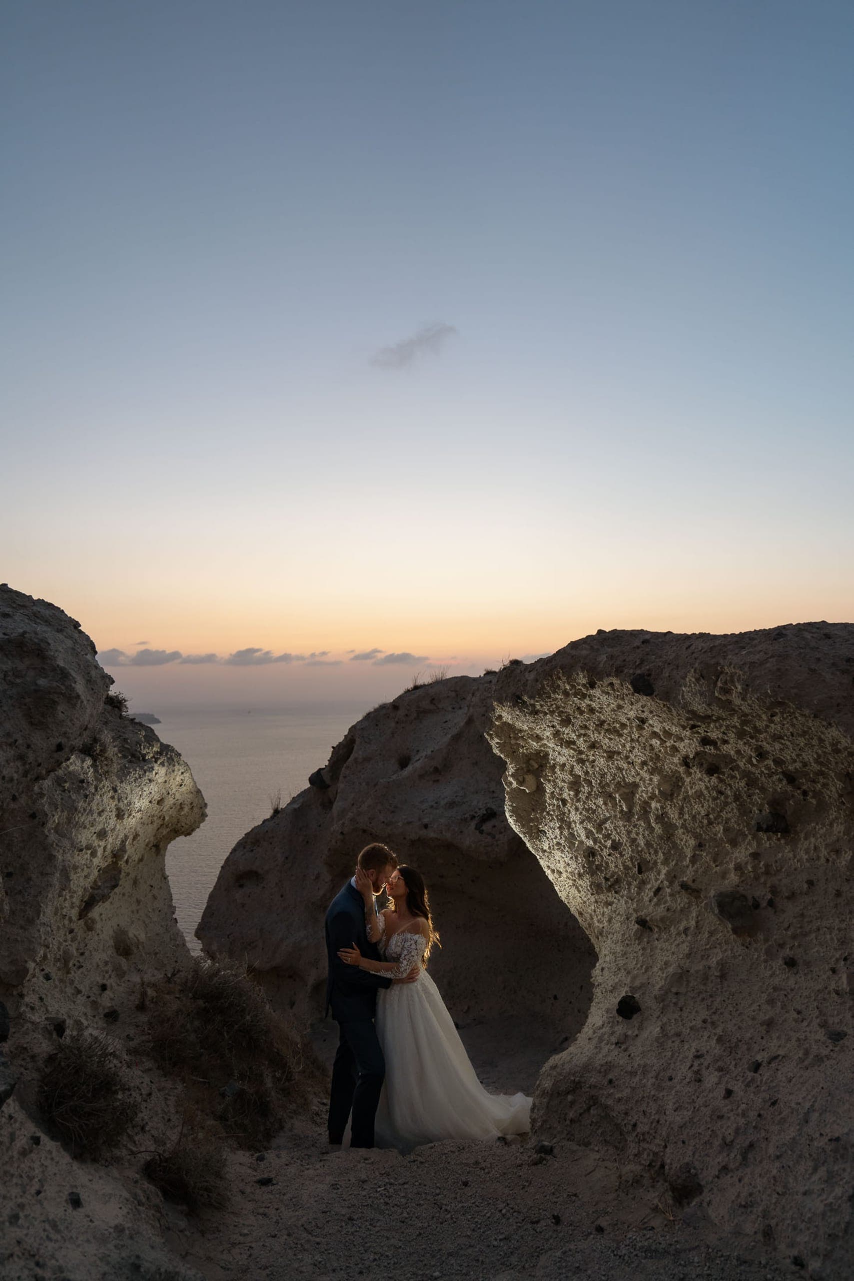 Wedding couple kissing at the heart of Santorini.