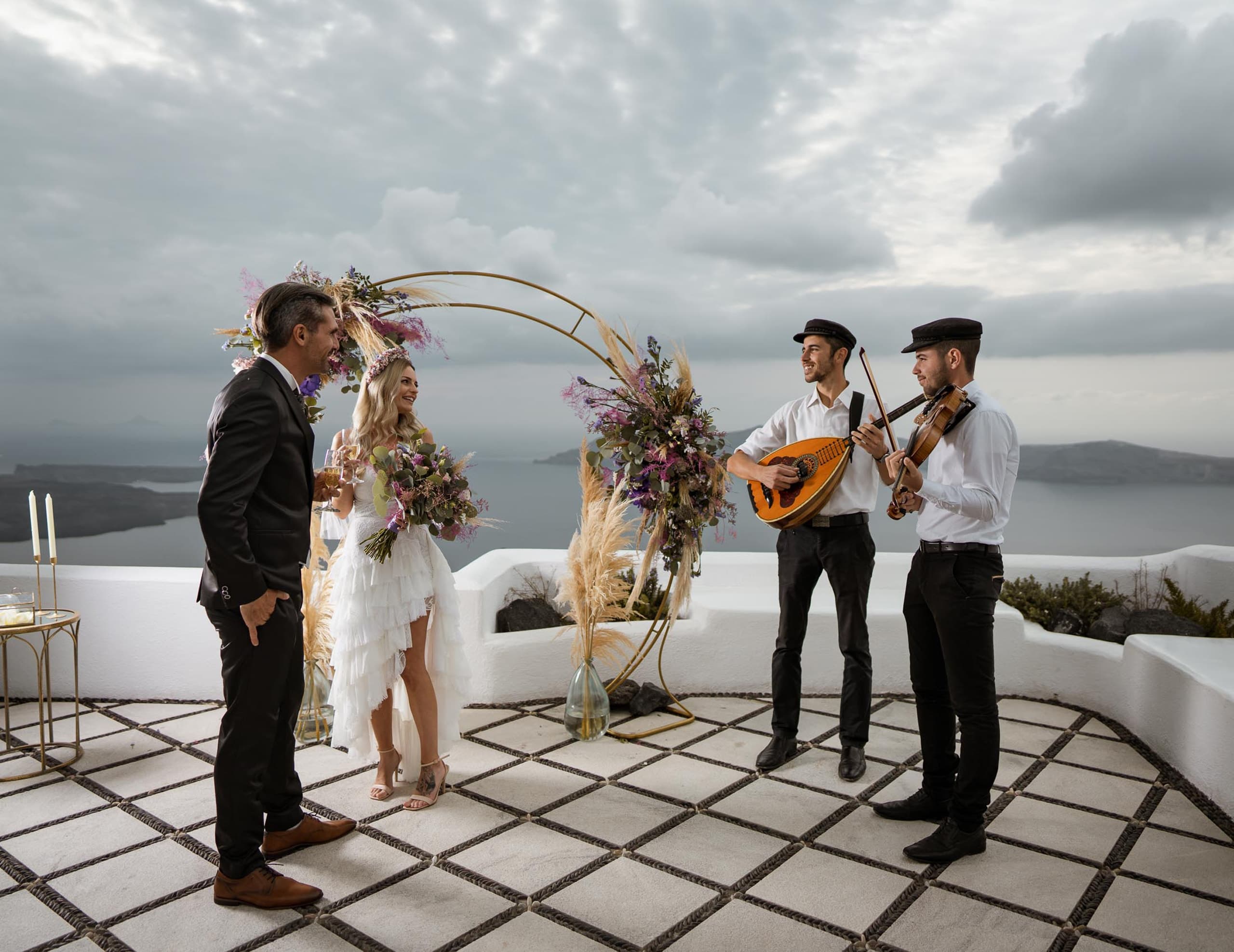 Wedding musicials playing traditional Greek music in a wedding ceremony in Santorini.