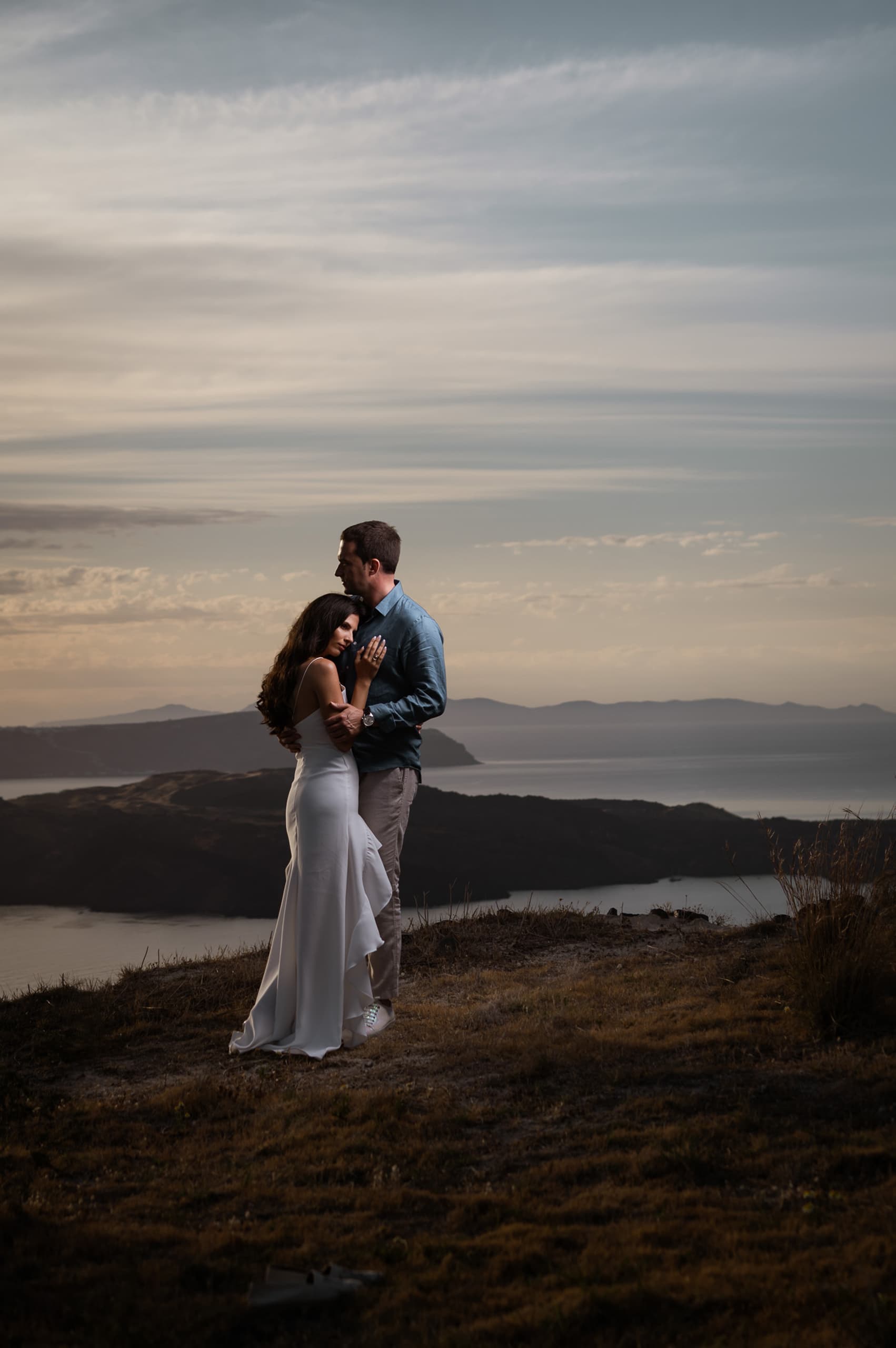 Couple posing against the caldera at Sunset.