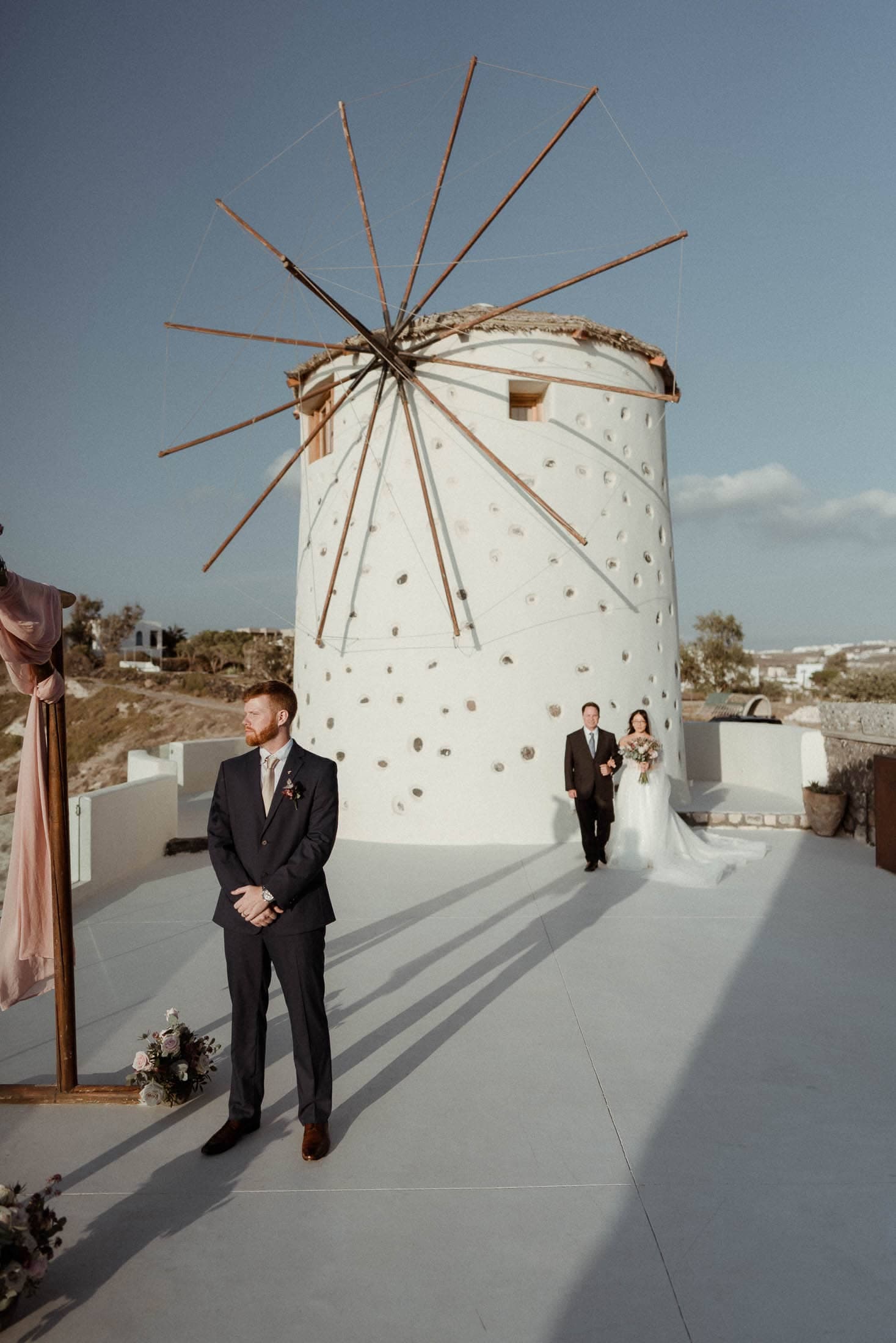 Bride's entrance holding her father's hand at El Viento wedding venue in Santorini.