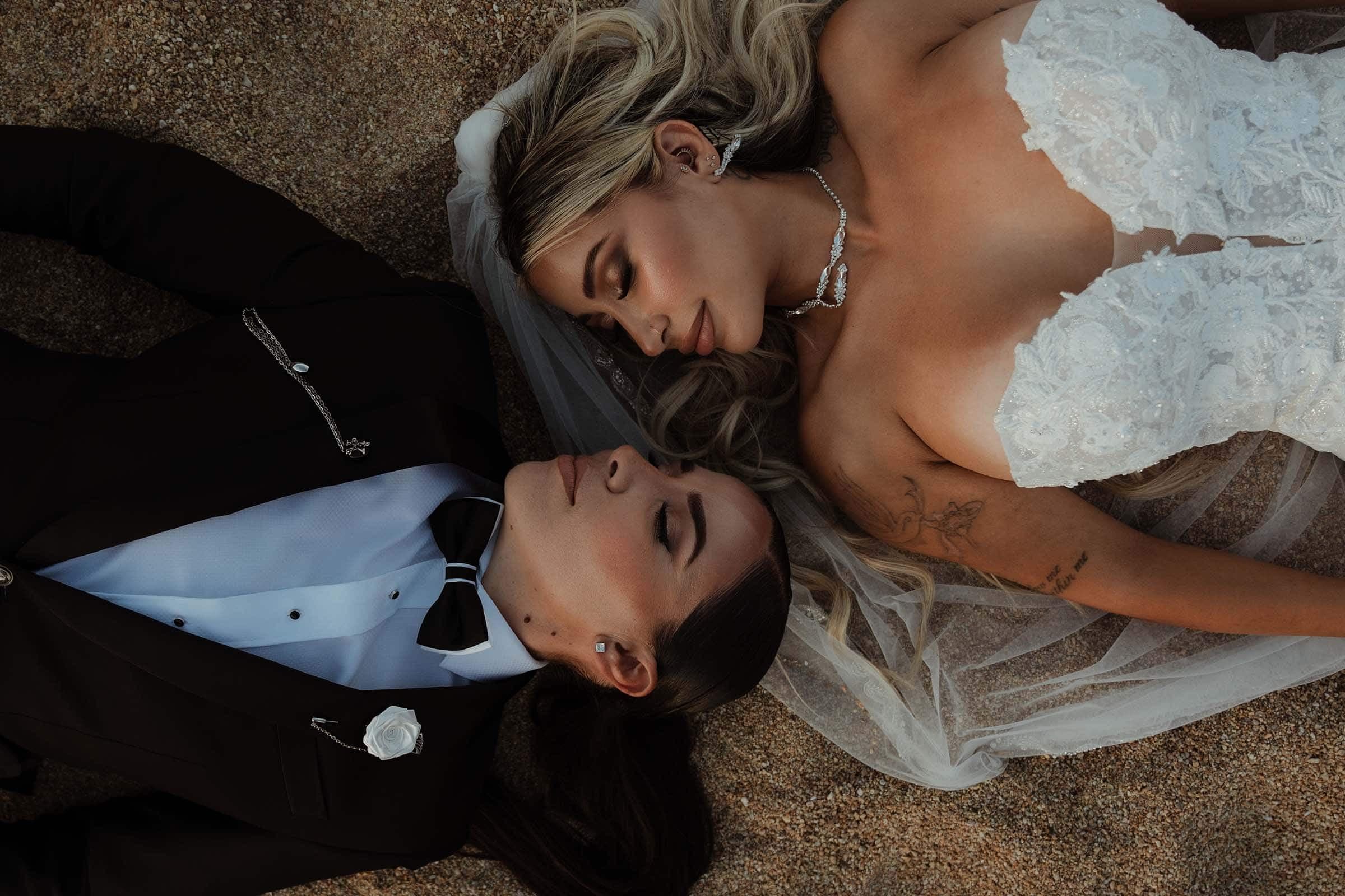 Lesbian wedding in Ios. Two girls laying at the sand in Calilo's private beach in Ios island.